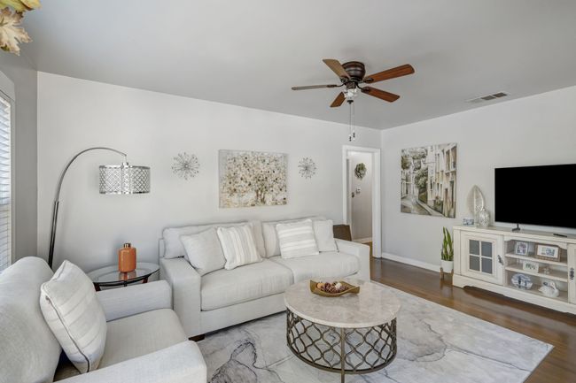 Living room with ceiling fan and hardwood / wood-style flooring | Image 6
