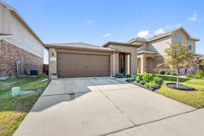 View of front of house with a front lawn, central AC, and a garage | Image 3