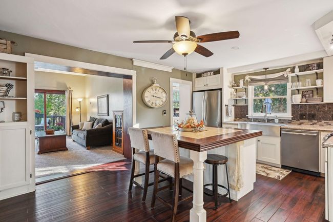 From here you can see the entrance the the generous sized family room and another peek at the butler's pantry. The window over the sink looks out over the large side yard and patio. | Image 13