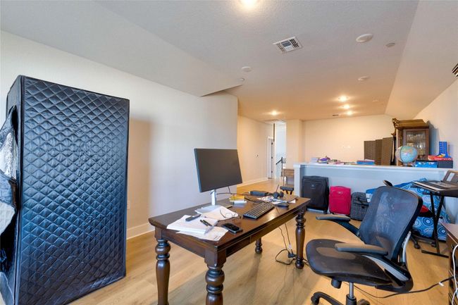 Home office with baseboards, visible vents, and light wood-style floors | Image 18