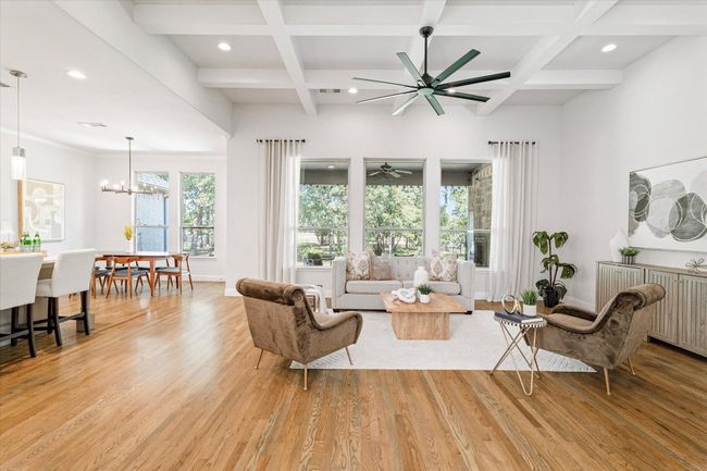 Living area featuring coffered ceiling, a ceiling fan, light wood-type flooring, beam ceiling, and recessed lighting | Image 5