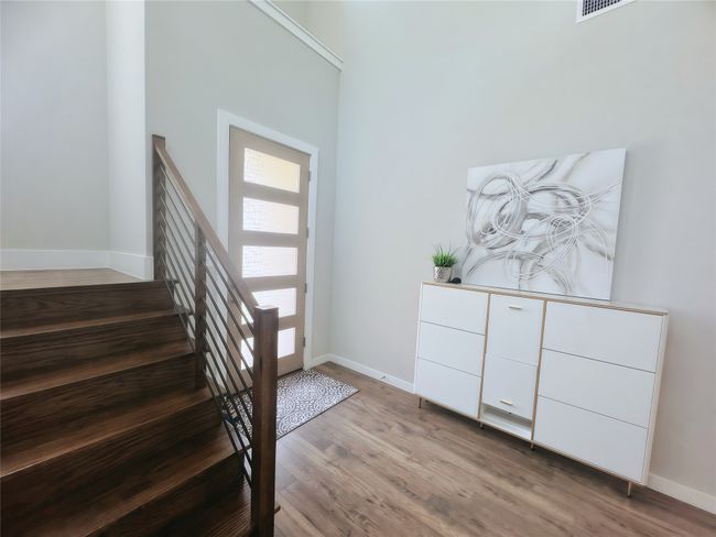 Entryway featuring wood finished floors, baseboards, and stairway | Image 5