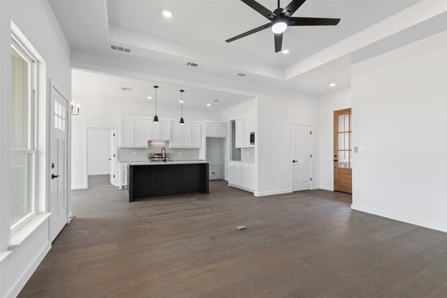 Unfurnished living room with a raised ceiling, recessed lighting, and visible vents | Image 10