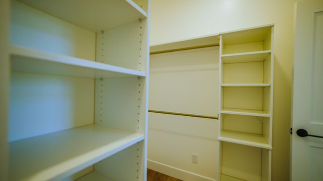 Spacious closet with wood finished floors | Image 31