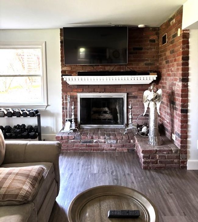 Grand Brick Corner Fireplace in the Lower Level Game Room | Image 42