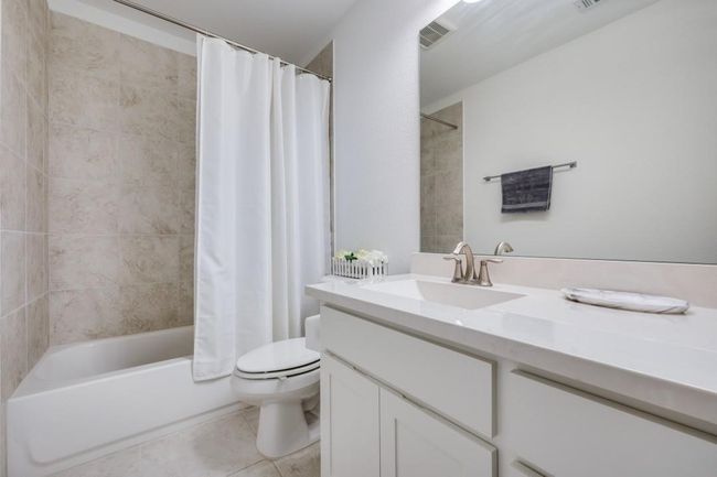 Full bathroom featuring vanity, toilet, tile patterned floors, and shower / bath combo with shower curtain | Image 24