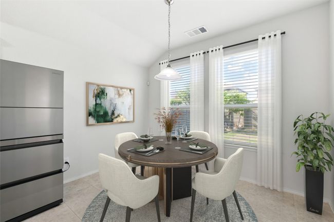 Dining space featuring vaulted ceiling, light tile patterned flooring, visible vents, and baseboards | Image 27
