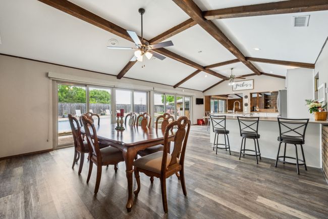 Oversized Dining Area Opens to Kitchen with Backyard Access | Image 14