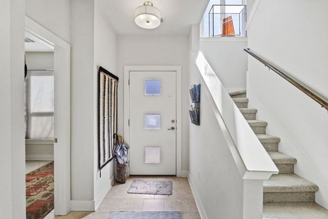 Foyer featuring stairs, baseboards, and light tile patterned floors | Image 15