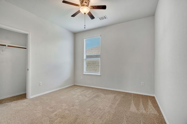 Unfurnished bedroom with carpet floors, a closet, and a ceiling fan | Image 24