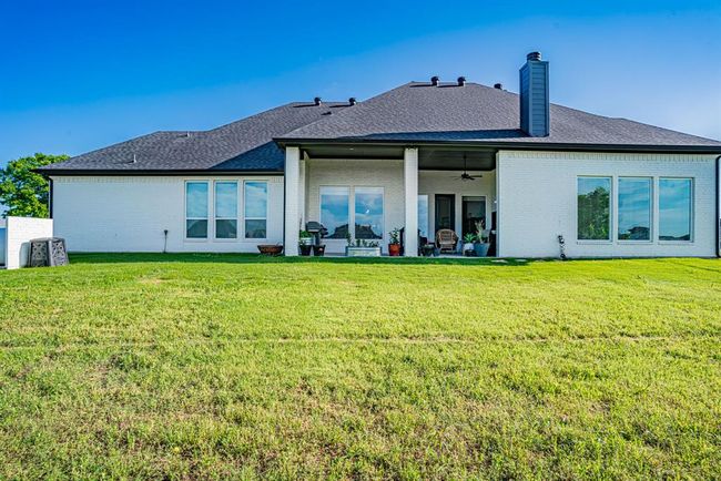 Back of house with a patio, ceiling fan, and a lawn | Image 37