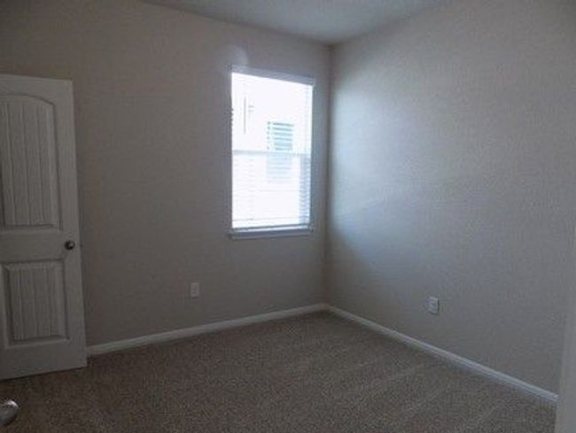 Carpeted spare room with healthy amount of natural light and baseboards | Image 12