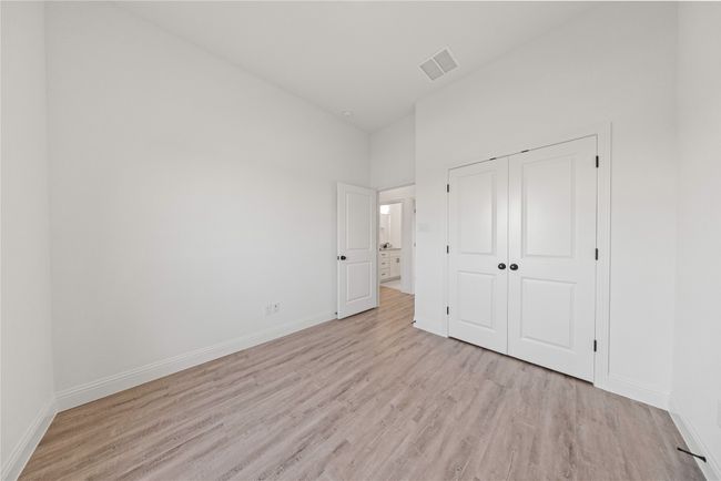 Unfurnished bedroom featuring light wood finished floors, baseboards, and a closet | Image 8