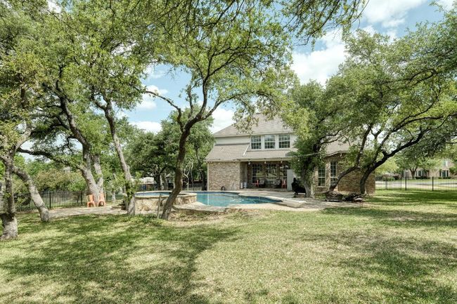 View of swimming pool with fence, a fenced in pool, and a yard | Image 31