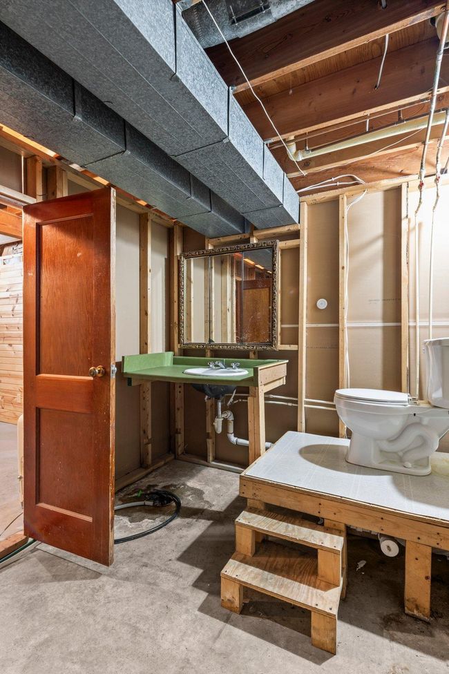 An unfinished half-bathroom in the basement, conveniently located just steps from the third bedroom. | Image 15