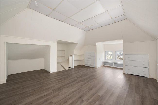 Bonus room with lofted ceiling and wood finished floors | Image 16