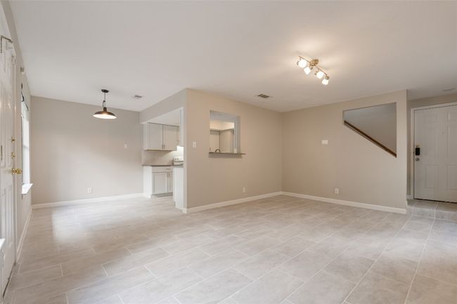 Spacious open layout connects living, dining, and kitchen—perfect for entertaining or cozy nights in. Fresh modern finishes throughout. | Image 4