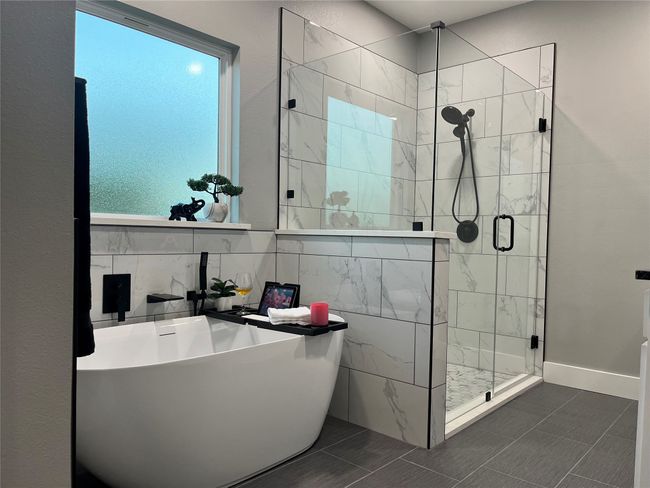Full bath with a stall shower, a soaking tub, and tile patterned floors | Image 25