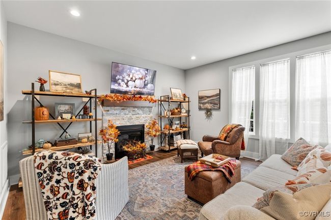 Living room with recessed lighting, wood finished floors, and a fireplace | Image 12