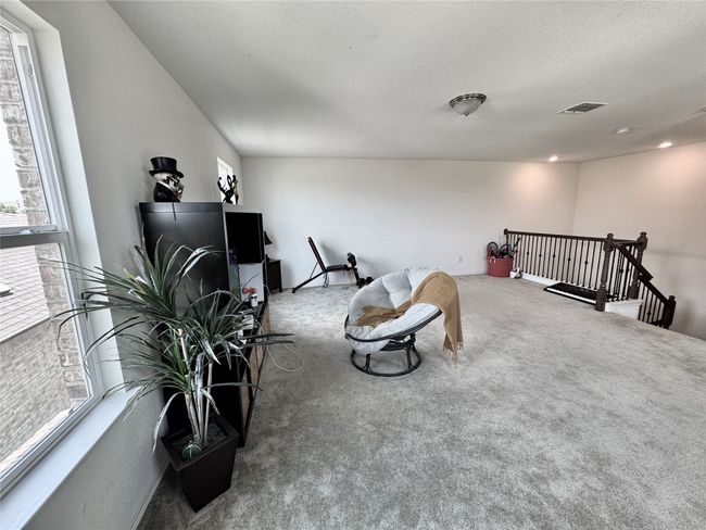 Living area with carpet flooring and an upstairs landing | Image 25