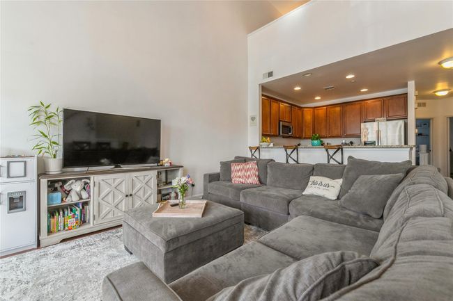 Living area featuring a towering ceiling, visible vents, and recessed lighting | Image 5