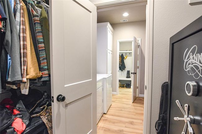 Walk in closet featuring light wood-style flooring and washer and clothes dryer | Image 20