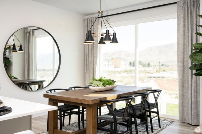 Dining space featuring a mountain view and light wood-style floors | Image 6