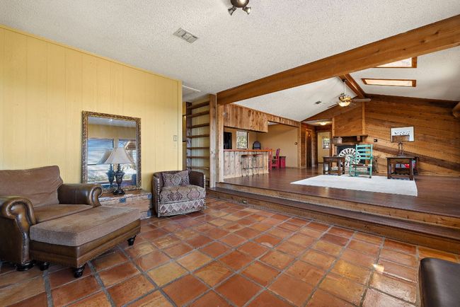 Living area featuring lofted ceiling with skylight, and tile floors | Image 12
