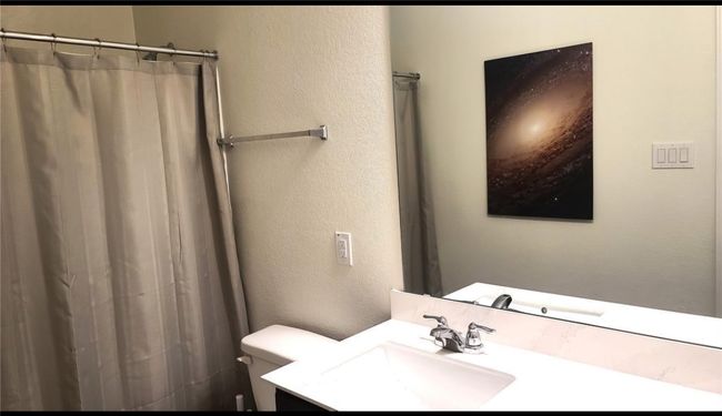 Full bath with vanity, a shower with curtain, and a textured wall | Image 8