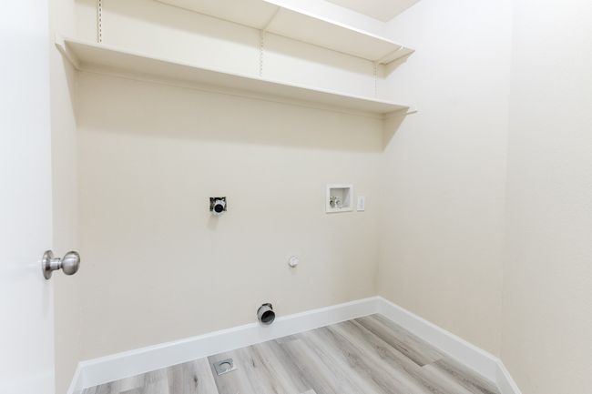 Clothes washing area with laundry area, baseboards, hookup for a gas dryer, light wood-style floors, and washer hookup | Image 21