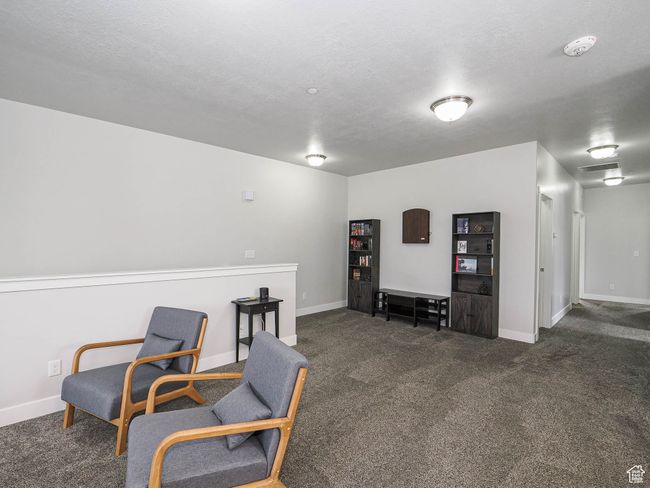 Sitting room with baseboards, carpet floors, and a textured ceiling | Image 11