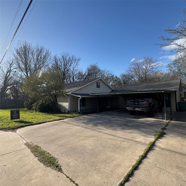 View of property exterior featuring concrete driveway | Image 17
