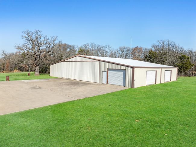 Concrete floored hangar has apartment and private office | Image 25