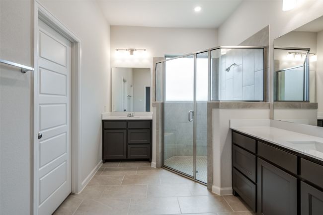 Bathroom featuring tile patterned flooring, vanity, and an enclosed shower | Image 18
