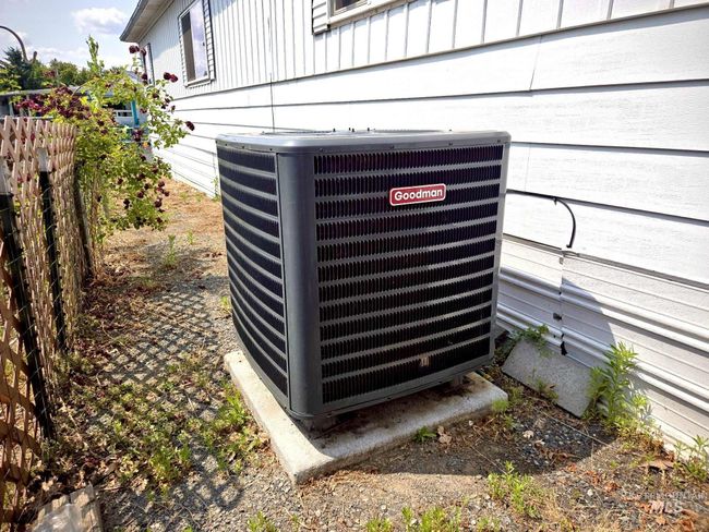 Exterior view of a cooling unit and board and batten siding | Image 6
