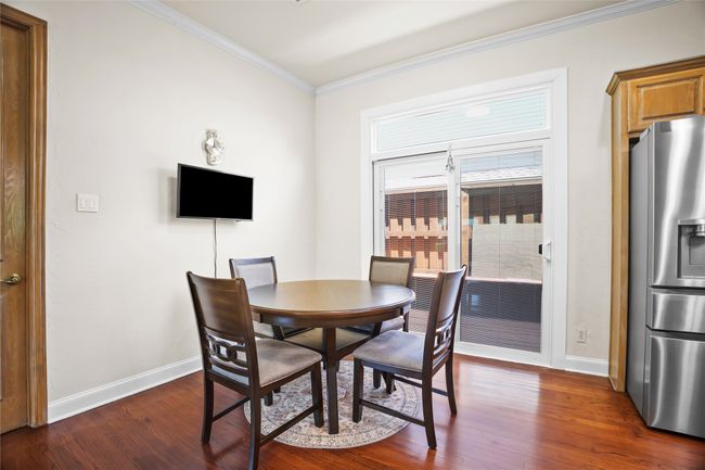 Dining space featuring dark wood-style floors and crown molding | Image 10
