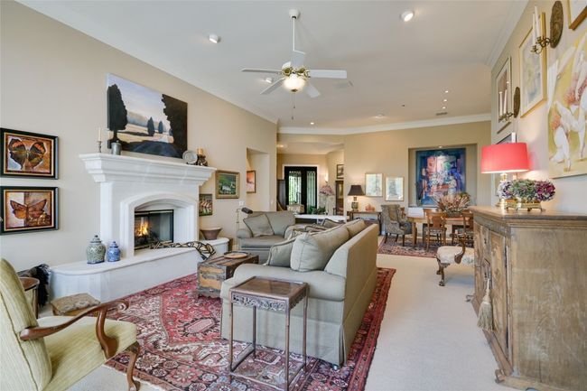 Living area with tall ceilings and a fireplace | Image 8