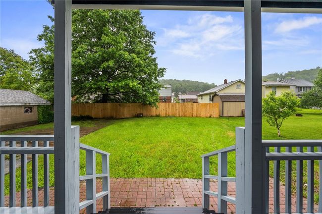 View of the flat yard from the back porch | Image 21
