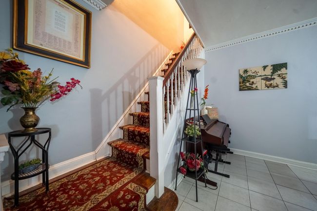Staircase featuring tile patterned flooring and baseboards | Image 16