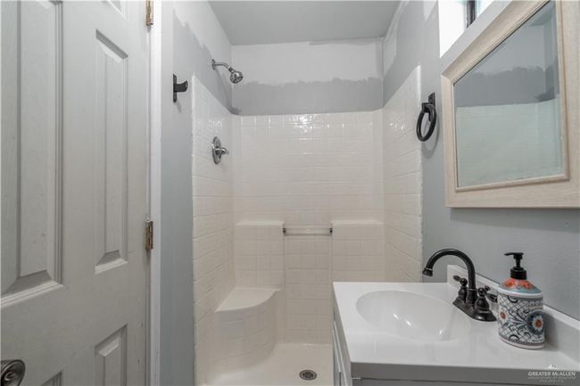 Bathroom featuring a shower and vanity | Image 16