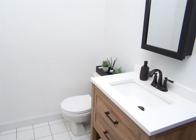 Bathroom with vanity, tile patterned floors, and toilet | Image 9