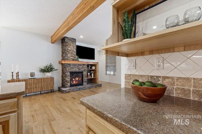 Living room featuring a fireplace, light wood-type flooring, beam ceiling, recessed lighting, and a textured ceiling | Image 14