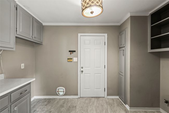 Laundry area featuring baseboards and crown molding | Image 17