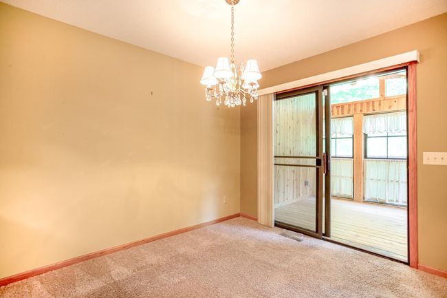 Intimate dining area with sliding glass doors leading to the 3-season porch—bringing natural light and fresh air inside. | Image 12
