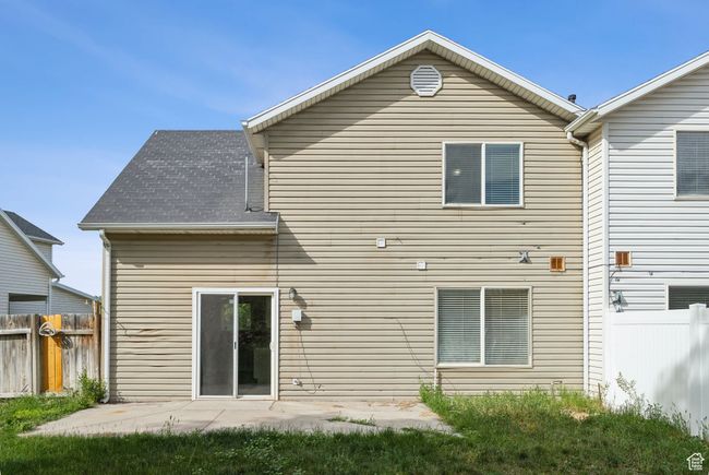 Rear view of property with a patio area and a shingled roof | Image 18
