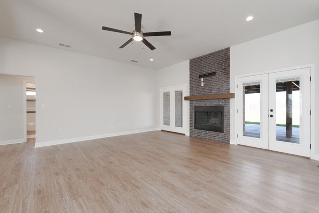 Unfurnished living room with ceiling fan, recessed lighting, french doors, light wood finished floors, and baseboards | Image 16