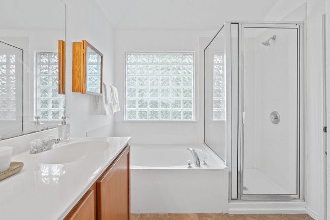 Bathroom with vanity, a stall shower, and a bath | Image 20