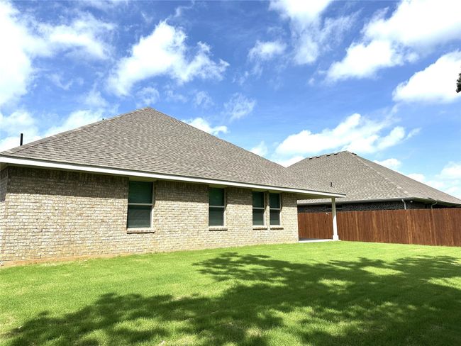 Back of property featuring roof with shingles and brick siding | Image 26