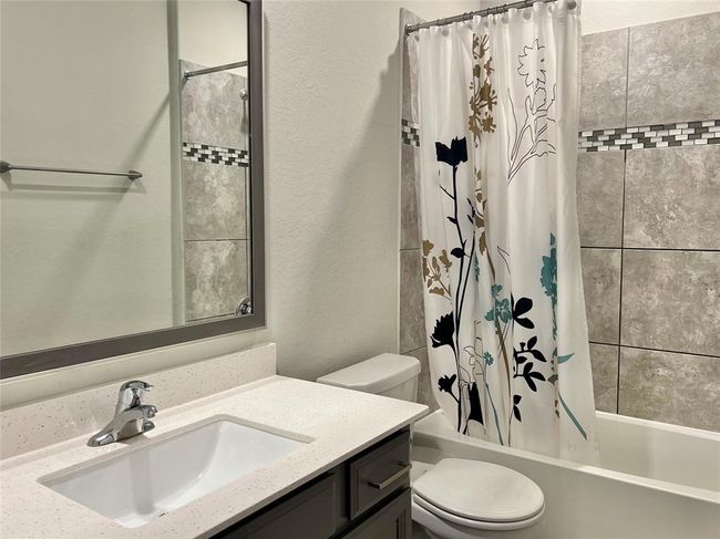 This home features stunning upgraded tile throughout, adding a touch of elegance to every room. | Image 17