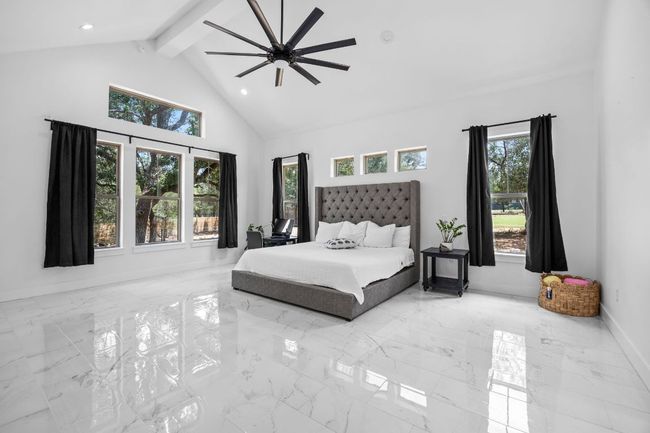 Bedroom with tile floors, recessed lighting, high vaulted ceiling, beamed ceiling, and ceiling fan | Image 13